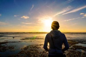 woman looking out into the sunset