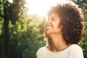 Woman smiling after recovering from substance abuse