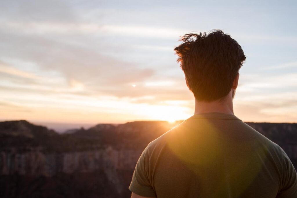 male looking at a sunset