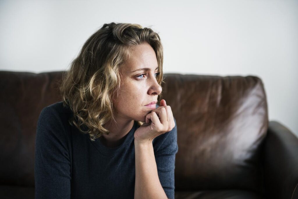 Women looking to the side on a leather couch