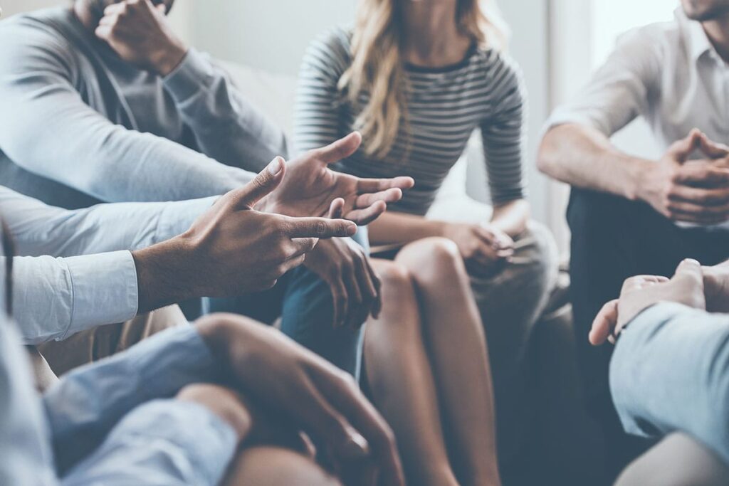 people talk in group therapy at a treatment center for depression and anxiety