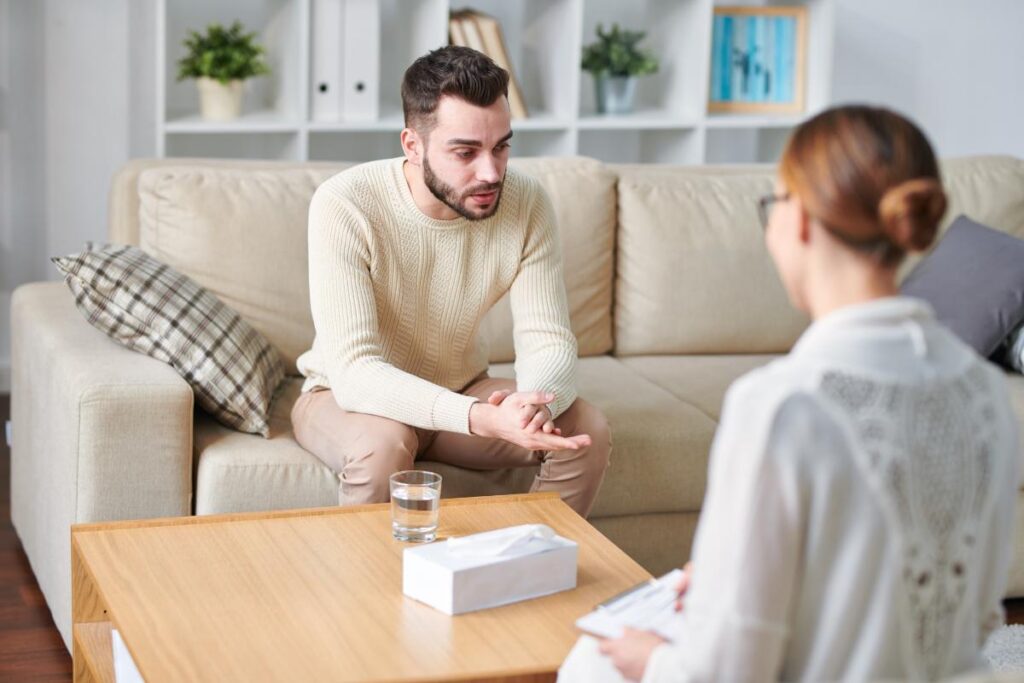 Patient sits on couch, asking "what is the detox process?"