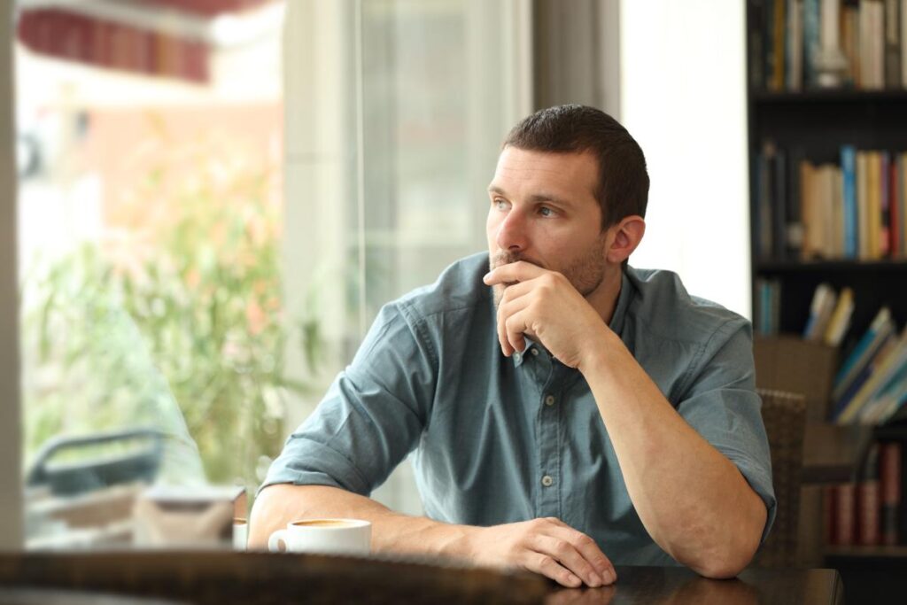 a person sits at their desk pondering how to manage alcohol cravings