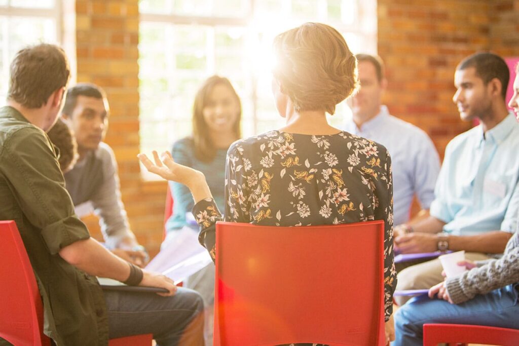 a group of people talk in a circle in iop treatment near camp hill pa