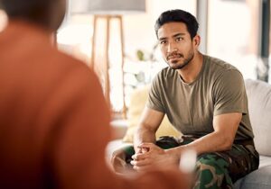 a person in fatigues meets with a therapist for veterans treatment