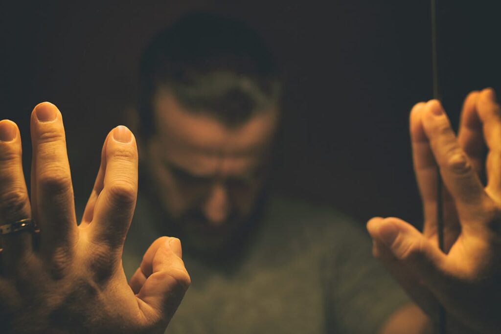 a person puts his fingers on a mirror to show the things you should know about fentanyl
