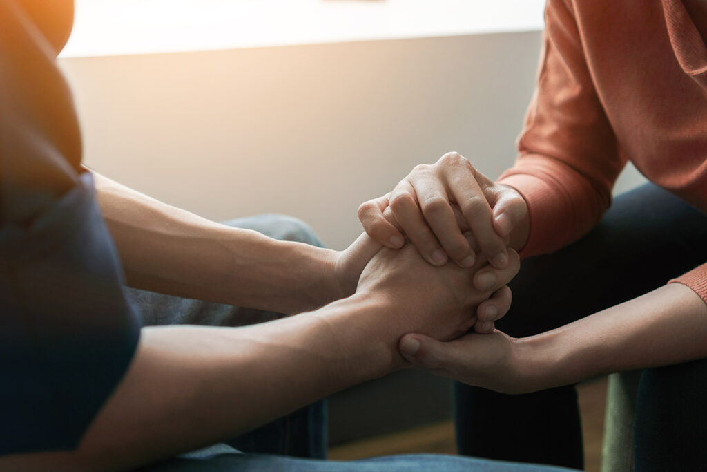 people hold hands during a Detox Program near Baltimore, MD