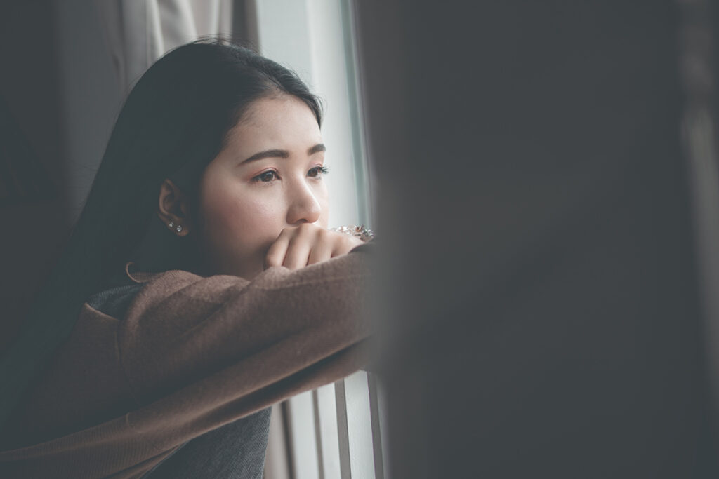 Woman thinking about long-term effects of alcohol abuse