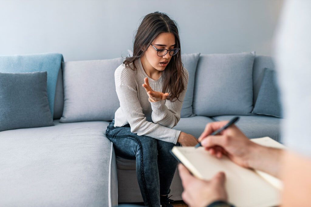 Woman asking about the cost of an anxiety treatment center