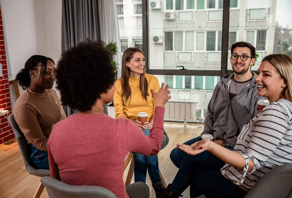 Five people sit in a circle, participating in an alcohol detox program in PA.