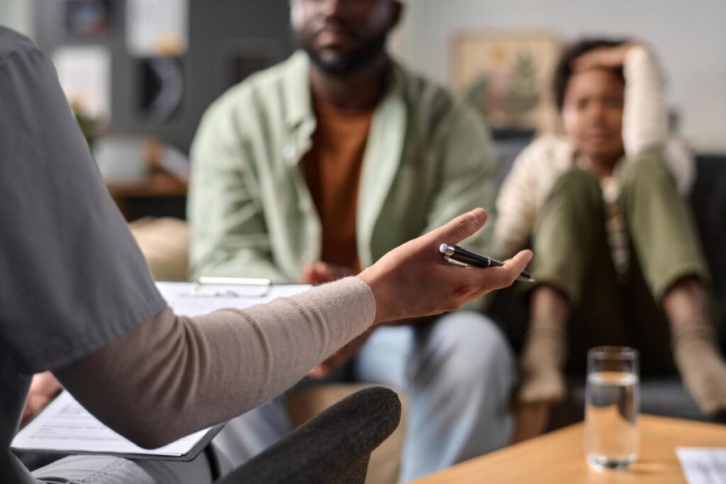 A couple talks to a therapist about opioid rehab.
