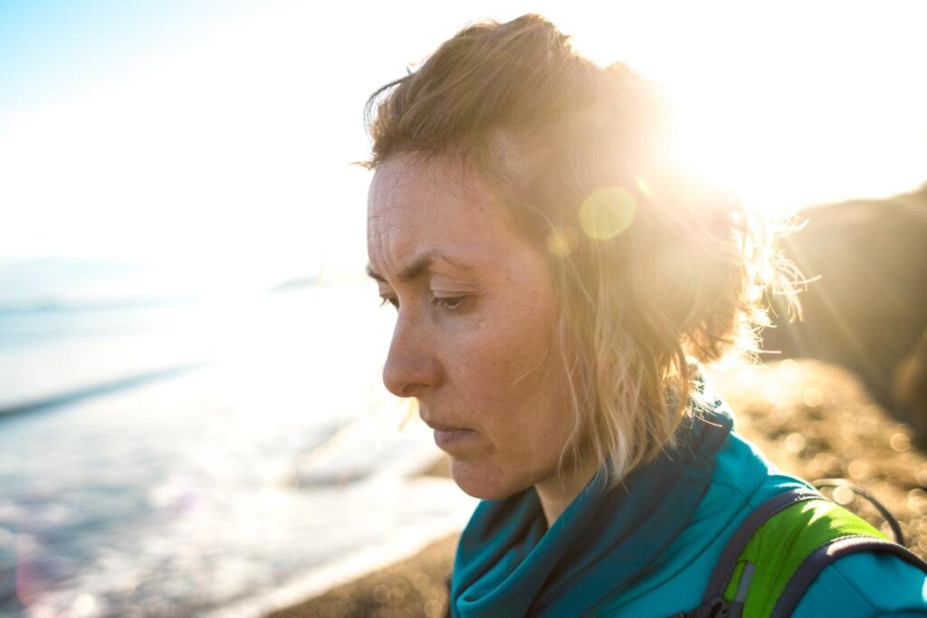 A woman on the beach is experiencing meth withdrawal symptoms.