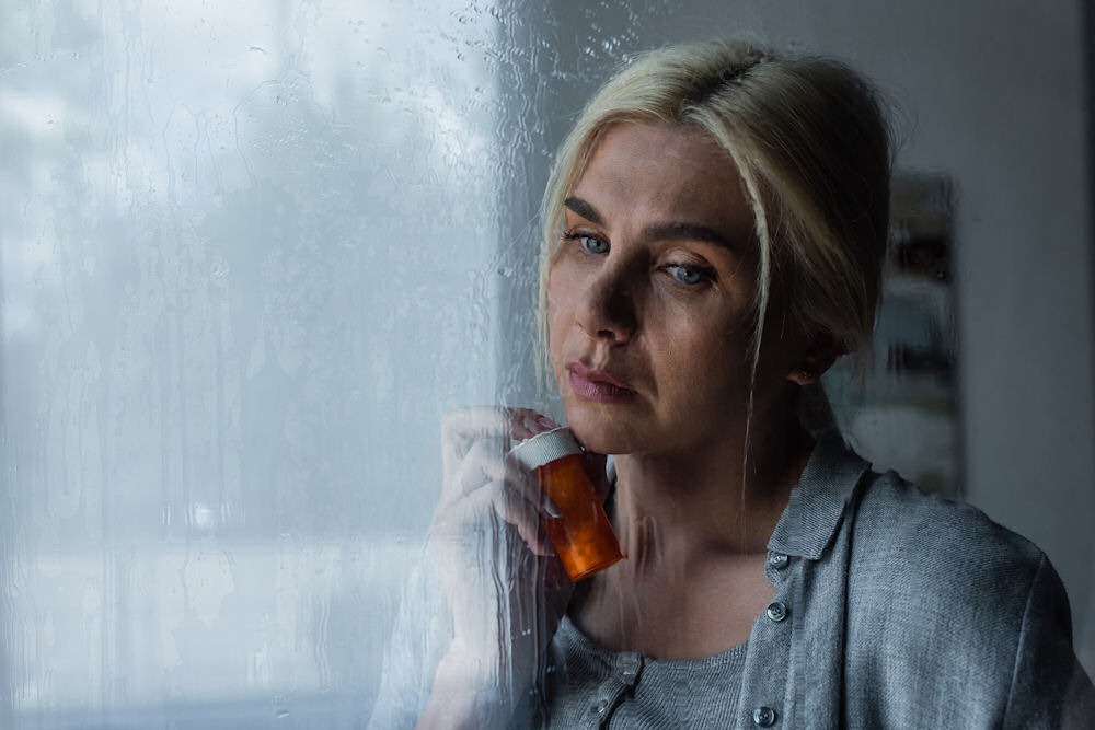 a woman holding a bottle of benzos