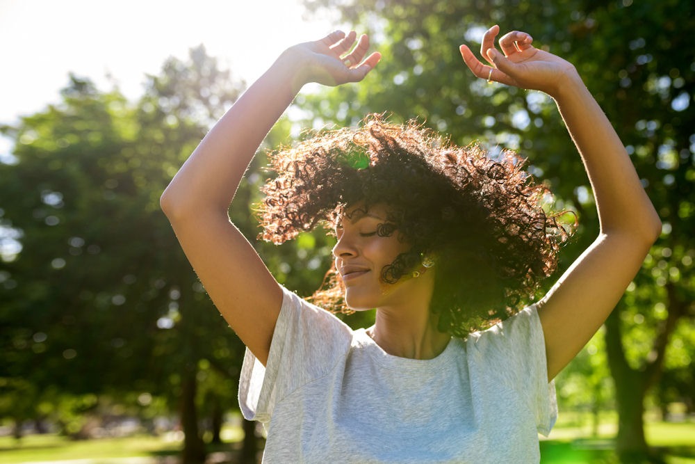 happy woman celebrating outdoors